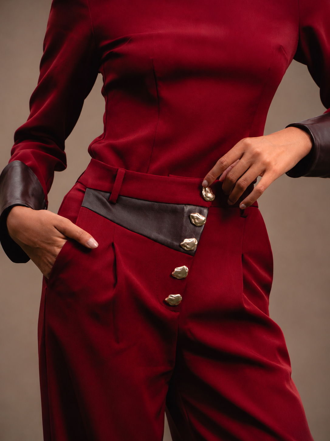 RŪH 04 Leather Trousers showing the high-rise waist and gold-tone button closure